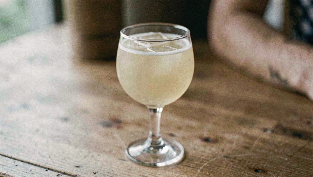 A sherry cobbler in a tall glass with crushed ice and citrus